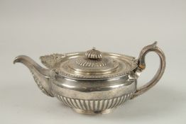 A SMALL GEORGE III SILVER CIRCULAR TEA POT with acanthus and shell Scrolls. 16cm diameter. London