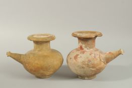 TWO EARLY POTTERY VESSELS with spouts. 18cm high.