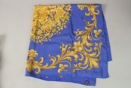 AN ASPREY'S BLUE AND GOLD SILK SCARF. 85cms x 85cms, in an Asprey's box.