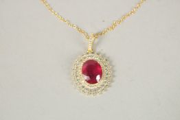 A SILVER GOLD PLATED RUBY PENDANT AND CHAIN.