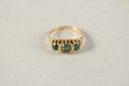 AN 18CT GOLD EMERALD AND DIAMOND GYPSY RING.