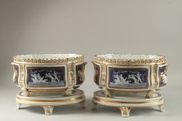 A MATCHING PAIR OF OVAL JARDINIERES AND STANDS. 32cm wide.