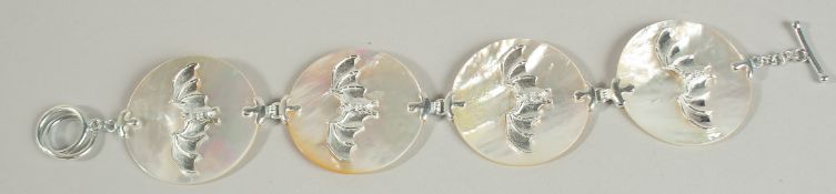 A SILVER AND MOTHER-OF-PEARL BAT BROOCH.