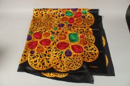 A LARGE CHANEL BLACK AND GOLD ETC. SILK SCARF. 140cms x 140cms.