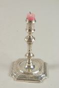 A GEORGE II SLVER TAPER STICK. London 1727, maker: James Gould. 12ins high.