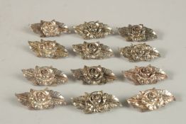 TWELVE VARIOUS METAL MENU HOLDERS.