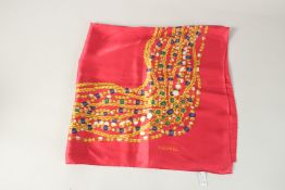 A CHANEL RED SILK SCARF. 90cms x 90cms.