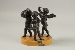 AFTER CLAUDE MICHEL CLODION (19TH CENTURY) THREE BRONZE MUSICANS PUTTI on an oval marble base.