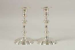 TWO GEORGE II MATCHING CAST SILVER CANDLESTICKS. London 1783 and 1791. 21cms high. Weight 33ozs.