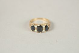 A 9CT GOLD THREE STONE SAPPHIRE AND OPAL RING. Ring size (O).