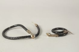 A BUTLER AND WILSON SNAKE NECKLACE AND BRACELET, boxed.
