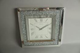 A SQUARE MIRRORED WALL CLOCK. 50cm