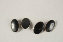 A PAIR OF SILVER AND BLACK ENAMEL CUFFLINKS.