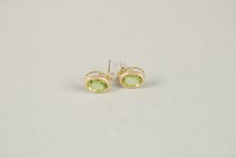 A PAIR OF 9CT GOLD PERIDOT EARRINGS..