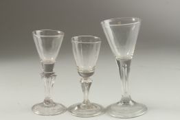 THREE CONICAL BASE WINE GLASSES. 16cm, 14cm & 13cm high.