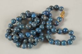 A STRING OF LAPIS BEADS. 80cms long.