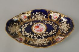 A ROYAL CROWN DERBY, OVAL BLUE GROUND DISH painted with flowers. 28cm long.