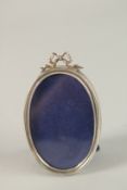 A CARTIER SILVER OVAL PHOTOGRAPH FRAME. 7cms x 5cms.