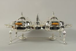 A GOOD SILVER PLATED DOUBLE SERVICE TUREEN AND COVER with salt and pepper on a stand, with burner