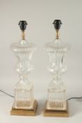 A PAIR OF URN SHAPED GLASS LANTERNS on square brass bases. 60cms high.