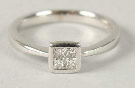 A 9CT WHITE GOLD 4 DIAMOND INVISIBLE SET RING, princess cut. Diamonds 0.32ct approx.