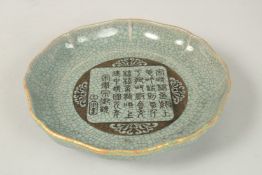 A CHINESE CELADON CRACKLE GLAZE DISH with characters. 21cms wide.