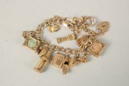 A 9CT GOLD CHARM BRACELET with sixteen charms. 55grms.