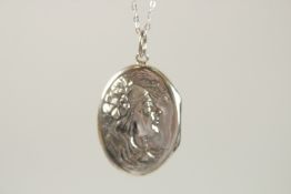 A SILVER ART NOUVEAU LADY OVAL LOCKET AND CHAIN.