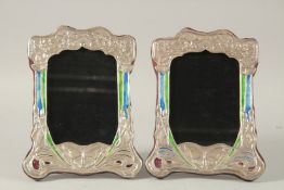A PAIR OF SILVER AND ENAMEL ART DECO DESIGN PHOTOGRAPH FRAMES.