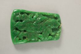 A GOLD RING JADE PENDANT.