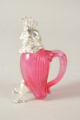 A SMALL RUBY GLASS AND SILVER PLATE PARROT CLARET JUG. 12cms high.