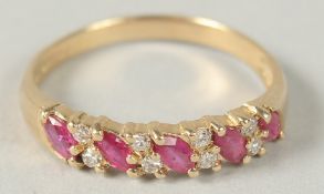 A 9CT YELLOW GOLD 9 STONE MARQUISE RUBY AND R/C DIAMOND RING, boxed.
