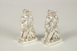 A PAIR OF ROYAL SEATED LION SALT AND PEPPERS. 8.5cms high.
