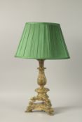 A 19TH CENTURY FRENCH GILT BRONZE LAMP on claw feet, complete with shade. 58cms high overall.