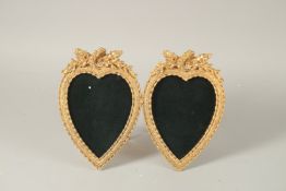 A GILT BRONZE DOUBLE HEART SHAPED PHOTOGRAPH FRAME. 25cms wide.