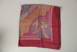 A CHRISTIAN DIOR BURGUNDY FLORAL SILK SCARF. 72cms x 72cms.