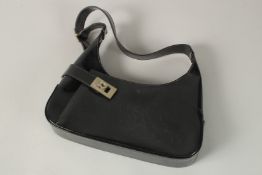 A FERRAGAMO BLACK LEATHER BAG. 30cms wide.