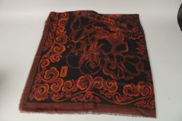 AN YVES SAINT LAURENT SCROLLS SILK SCARF. 72cms x 72cms, in a black bag.