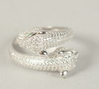 A SILVER DOUBLE PANTHER HEAD CROSSOVER RING. Ring size (P).