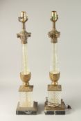 A GOOD PAIR OF CUT GLASS AND GILT METAL COLUMN LAMPS on square bases. 70cms high.