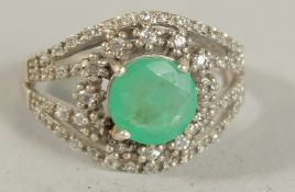 A 9CT GOLD, EMERALD AND DIAMOND RING.