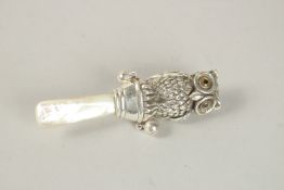 A SILVER AND MOTHER-OF-PEARL OWL RATTLE.