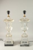 A PAIR OF URN SHAPED GLASS LANTERNS on square marble bases. 60cms high.