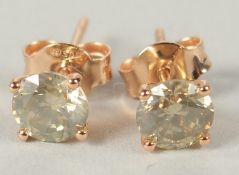 A PAIR OF 18CT ROSE GOLD 4 CLAW RBC DIAMOND SOLITAIRE STUD EARRINGS, boxed with certificate.