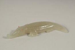 A RUSSIAN CARVED JADE CROCODILE with gold eyes. 11cms long, in a Faberge box.