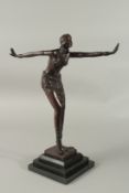 AFTER CHIPARUS. A BRONZE SNAKE DANCER on a stepped marble base.