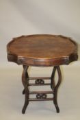 A CHINESE REDWOOD MAHJONG TABLE, 19TH CENTURY, the top of shaped circular outline, with four small