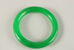 AN APPLE GREEN JADE BANGLE. 8cms diameter.