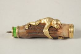 A RUSSIAN SILVER AND BONE MONKEY WALKING STICK HANDLE, a monkey clasp and a bow, with enamel top.