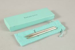 TWO TIFFANY PENS in a Tiffany bag.